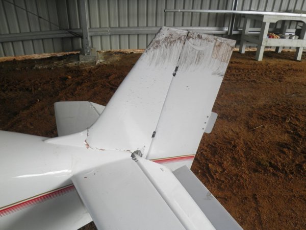 Fin .. held in place by the soil while the a/c tilted onto the pilot's side wing tip. Fractured the joints