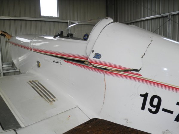 Broken longeron and ply panel behind the pilot. Longeron may have been 3/4 fractured since construction